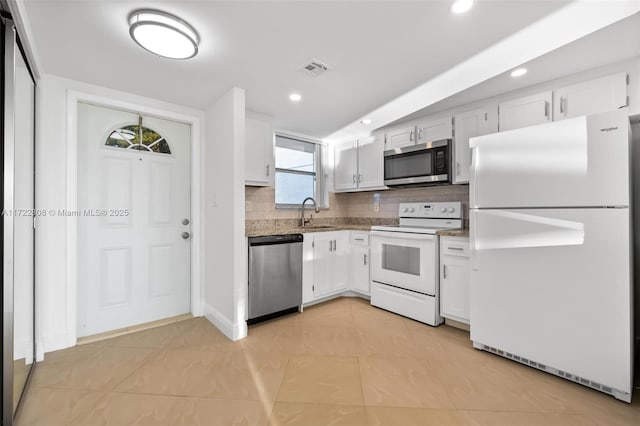 kitchen featuring a wealth of natural light, white cabinetry, and appliances with stainless steel finishes