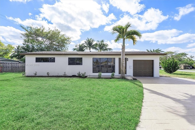 ranch-style house featuring a front lawn and a garage