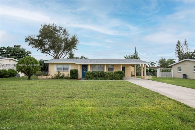 single story home with a front lawn and a carport