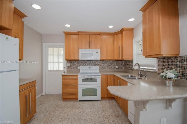 kitchen featuring kitchen peninsula, decorative backsplash, white appliances, and sink