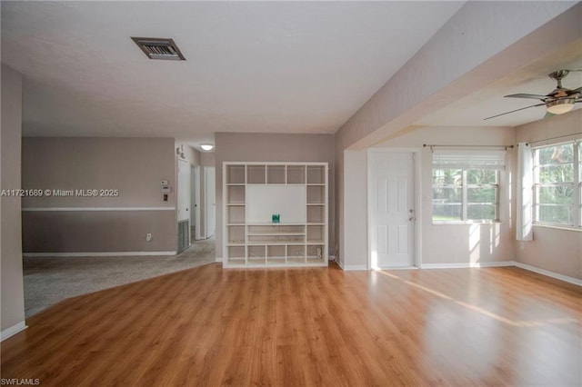 unfurnished living room with ceiling fan and light hardwood / wood-style floors