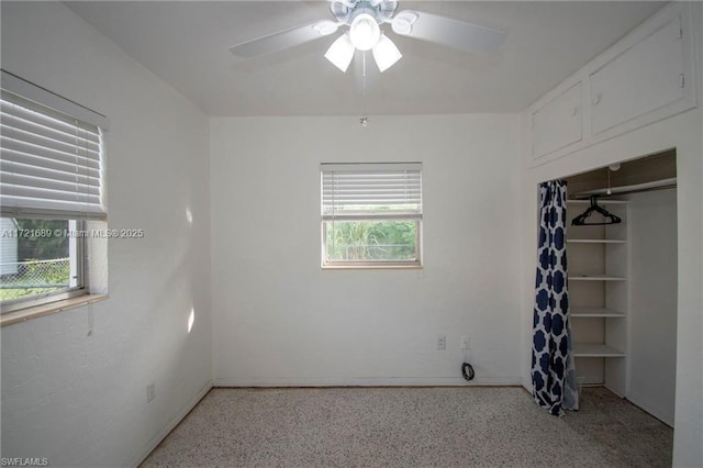 unfurnished bedroom featuring ceiling fan and a closet