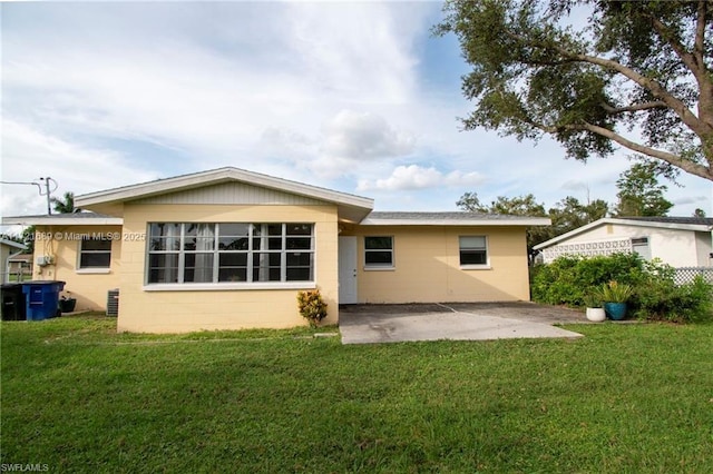 rear view of house featuring a yard and a patio