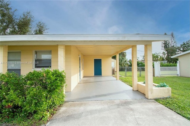 exterior space featuring a lawn and a carport