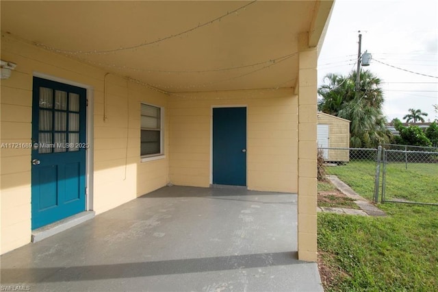 entrance to property with a lawn