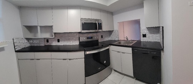 kitchen featuring white cabinets, sink, and appliances with stainless steel finishes