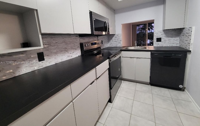 kitchen with white cabinets, stainless steel appliances, tasteful backsplash, and sink