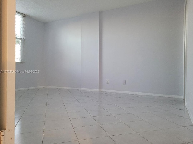 unfurnished room featuring light tile patterned floors