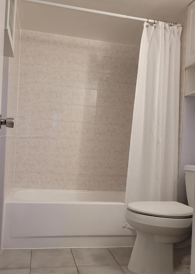 bathroom featuring tile patterned floors, shower / tub combo, and toilet