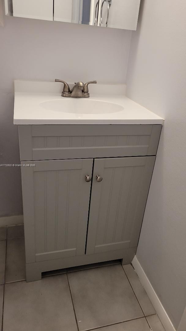 bathroom with tile patterned flooring and vanity