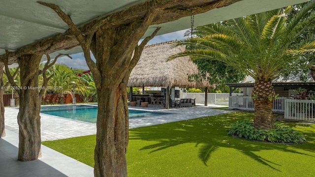 view of pool featuring an outdoor bar and a patio