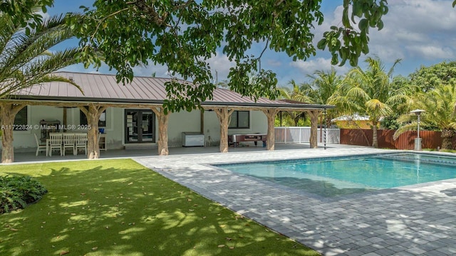 view of swimming pool featuring a yard and a patio