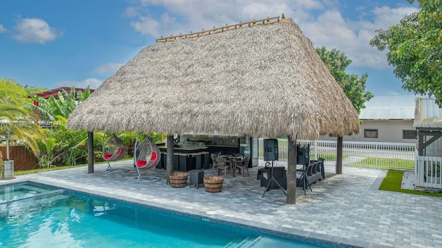 view of swimming pool with a gazebo, an outdoor bar, and a patio