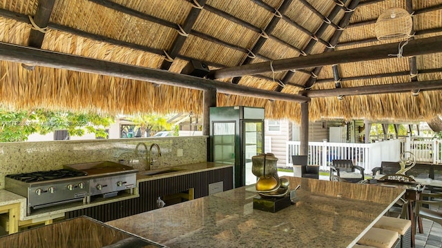 kitchen featuring vaulted ceiling with beams, sink, and wooden ceiling