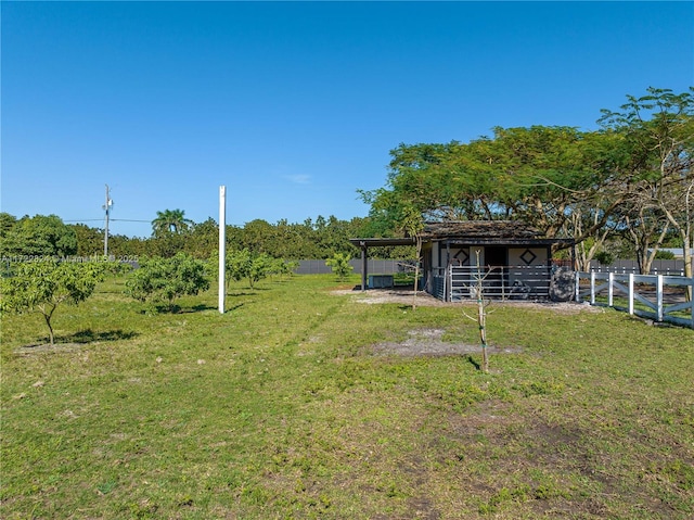 view of yard featuring a rural view and an outbuilding