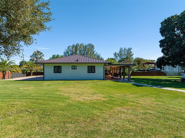 rear view of house featuring a lawn