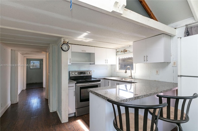 kitchen featuring sink, kitchen peninsula, white fridge, electric stove, and white cabinets