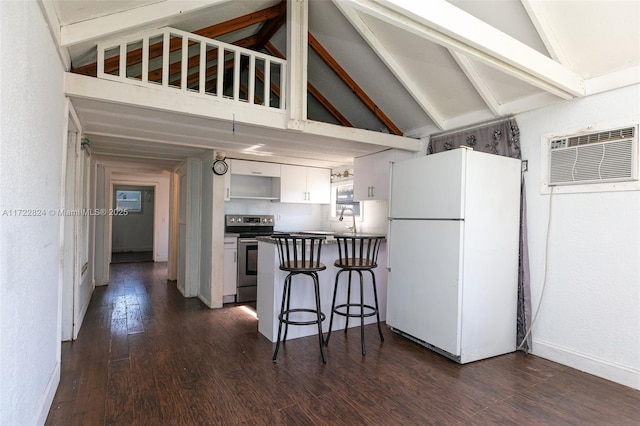 kitchen with white refrigerator, kitchen peninsula, a kitchen bar, electric stove, and white cabinets