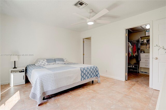 bedroom with ceiling fan, access to outside, and a textured ceiling