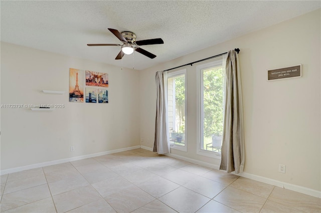 unfurnished room featuring a ceiling fan, light tile patterned flooring, a textured ceiling, and baseboards