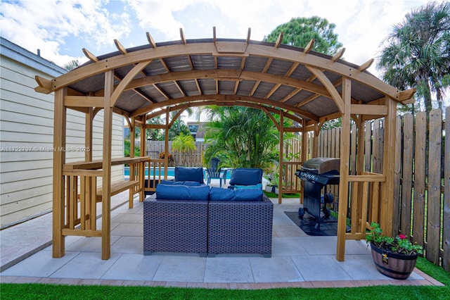 view of patio / terrace with a fenced backyard, a grill, and an outdoor living space