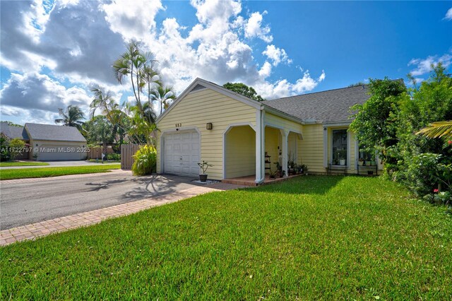 ranch-style house with a garage and a front yard