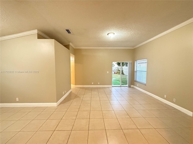 empty room featuring crown molding, light tile patterned floors, and a textured ceiling