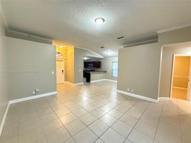 unfurnished living room with a textured ceiling, light tile patterned floors, lofted ceiling, and ornamental molding