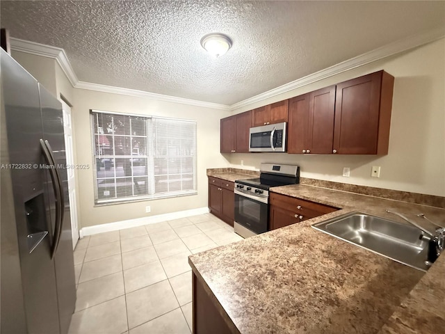 kitchen with sink, light tile patterned floors, a textured ceiling, ornamental molding, and appliances with stainless steel finishes