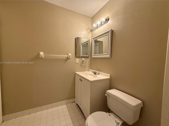 bathroom with tile patterned floors, vanity, and toilet