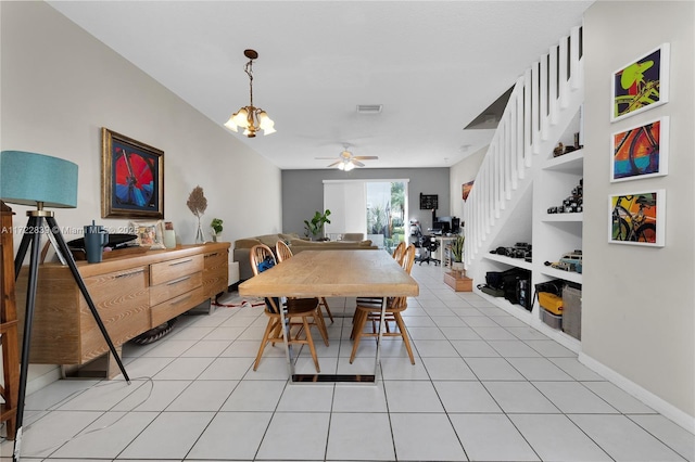 dining room featuring built in shelves, ceiling fan with notable chandelier, and light tile patterned flooring