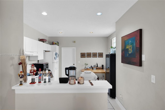 kitchen featuring kitchen peninsula, refrigerator, extractor fan, white cabinets, and light tile patterned flooring