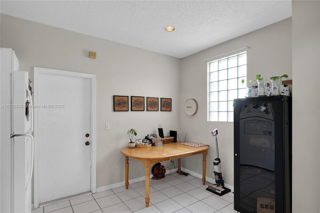 interior space featuring light tile patterned floors and a textured ceiling