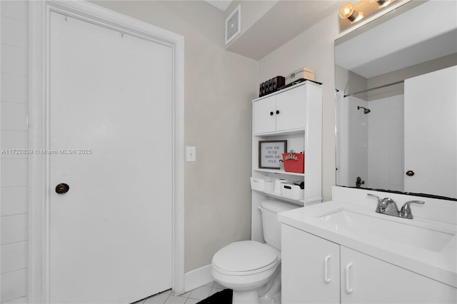 bathroom with tile patterned flooring, vanity, toilet, and tiled shower