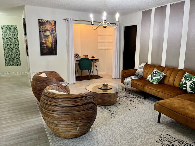 living room with hardwood / wood-style floors, a notable chandelier, and a textured ceiling