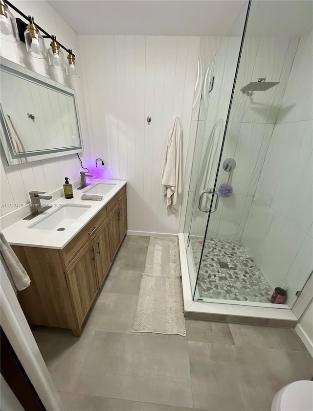 bathroom featuring concrete floors, vanity, and a shower with shower door