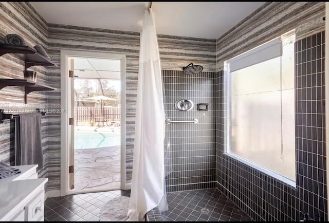 bathroom featuring a tile shower and tile patterned floors