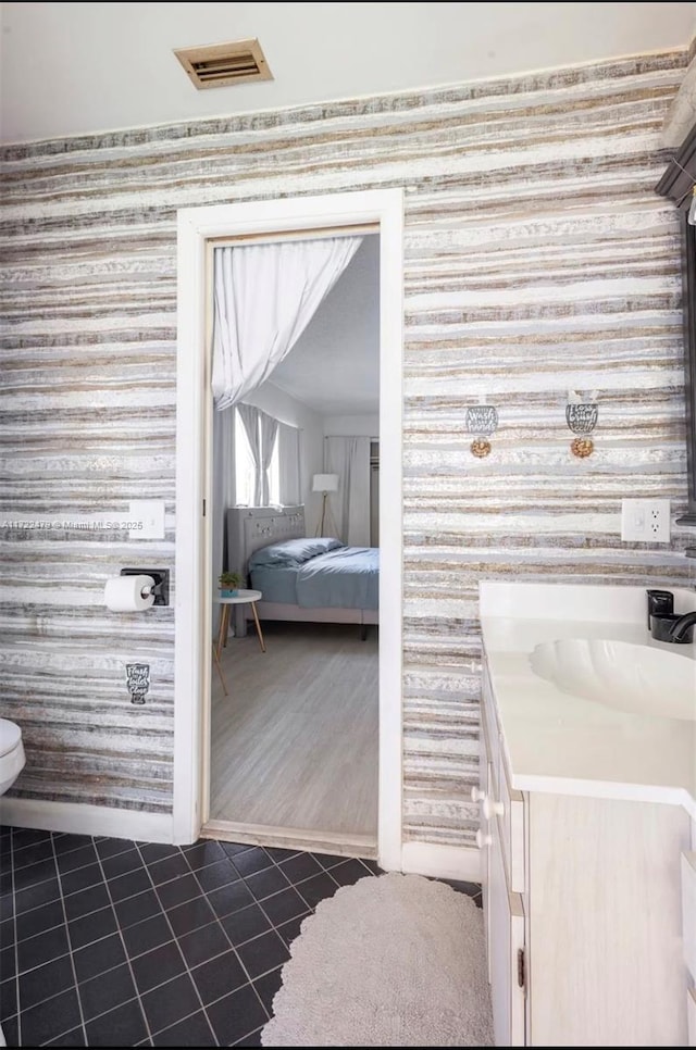 bathroom featuring tile patterned flooring and vanity