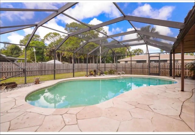 view of swimming pool with a lanai and a patio