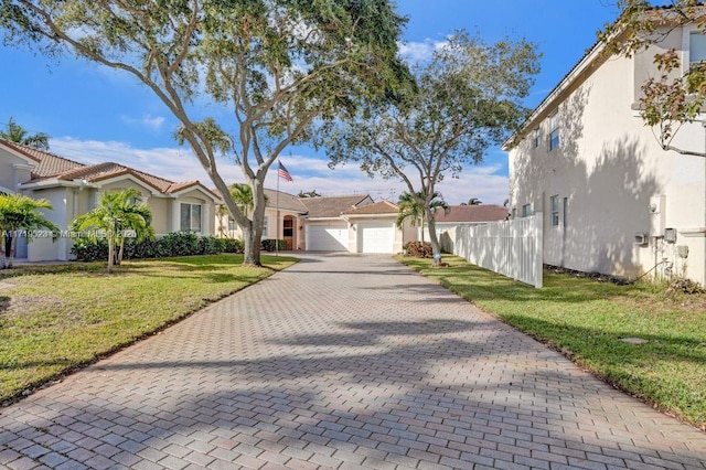 view of front of property with a garage and a front lawn