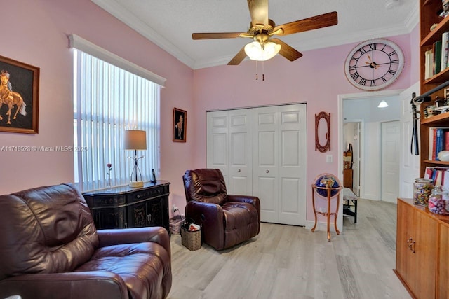 interior space with ceiling fan, crown molding, a textured ceiling, and light wood-type flooring