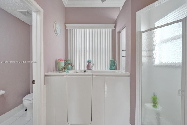 bathroom featuring an enclosed shower, tile patterned flooring, toilet, and a textured ceiling