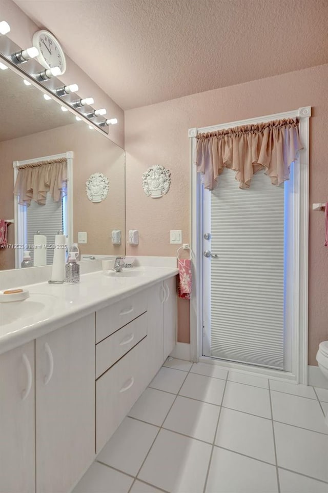 bathroom featuring vanity, a textured ceiling, and tile patterned flooring