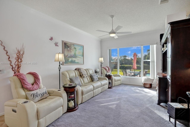 living room with ceiling fan, light carpet, a textured ceiling, and ornamental molding