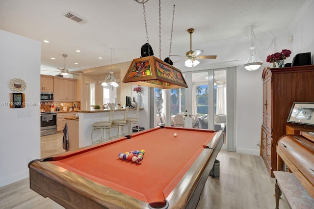 game room with french doors, light hardwood / wood-style floors, ceiling fan, and pool table