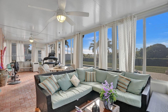 sunroom / solarium featuring ceiling fan