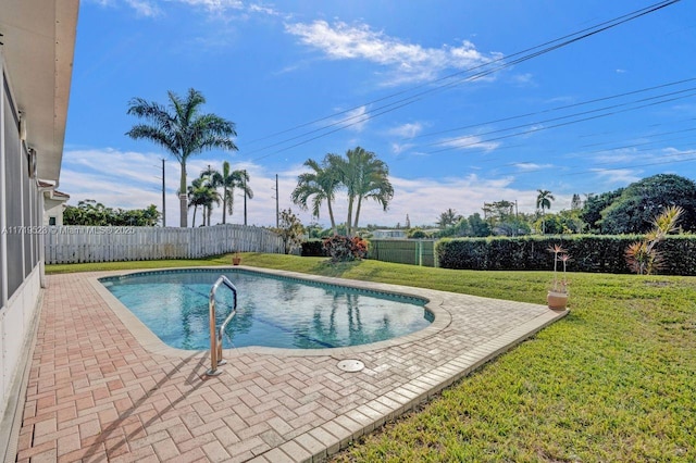 view of pool with a yard and a patio