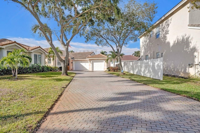 view of front of property with a garage and a front lawn