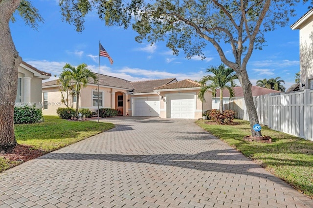 ranch-style home with a garage and a front lawn