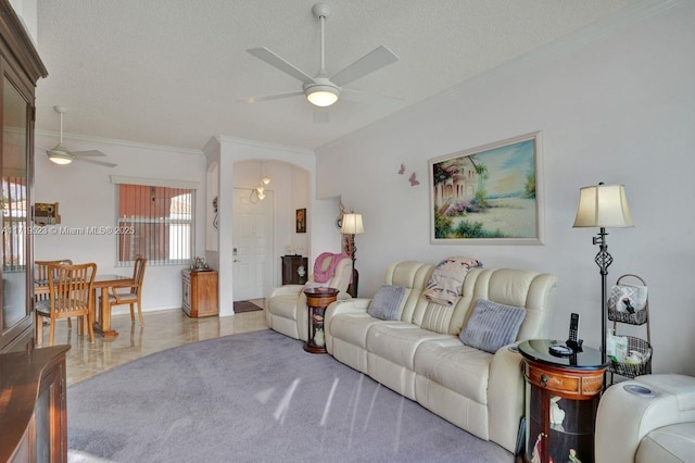 tiled living room with ceiling fan and a textured ceiling